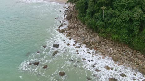 Calming-drone-shot-of-waves-smashing-into-the-rocky-coastline-on-beach-Island-of-Puerto-Galera