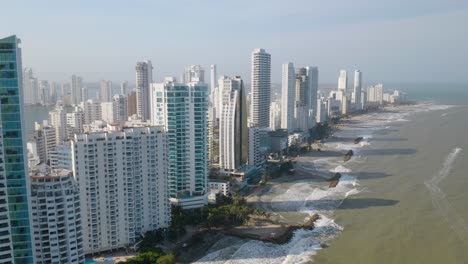 Aerial-Tracking-Shot-Along-Cartagena-Coastline-as-Waves-Crash-Along-Shoreline