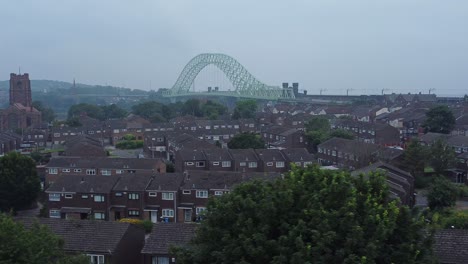 British-Northern-Runcorn-bridge-suburban-residential-townhouse-neighbourhood-aerial-view-dolly-right