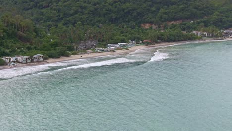 Nice-view-of-white-sandy-beach,-waves-slowly-crashing-to-the-seashore-on-Puerto-Galera,-Philippines