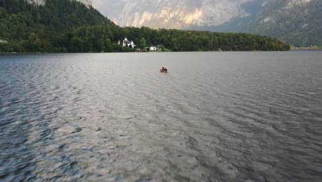 Traditional-Flatboat-or-Rowing-Boat-on-Lake-Hallstatt,-also-called-Fuhre-with-Tourists-on-a-Cruise