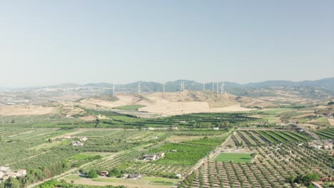 Panoramic-view-of-the-Calabria-coastline,-olives-fields,agricultural-fields-and-wind-turbines-in-the-background,-Calabria,-Italy