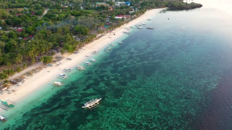 inematic-Aerial-Footage-of-Beautiful-turquoise-ocean,-white-beach,-palm-trees,-Carabao-Island-in-Romblon,-Philippines