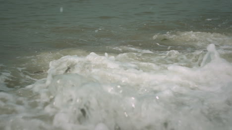 Close-up-of-a-wave-hitting-the-rocky-coast,-slow-motion