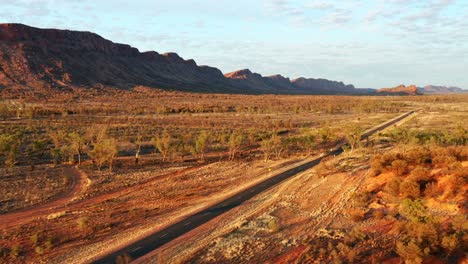 Long-Asphalt-Road-Amidst-The-Wilderness-With-A-View-Of-West-MacDonnell-Ranges-In-Alice-Springs,-Australia