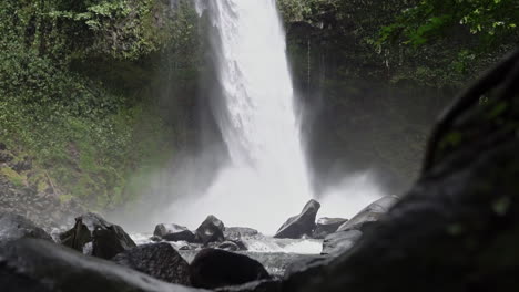 Shot-around-corner-revealing-La-Fortuna-waterfall-Costa-Rica-rainy-season