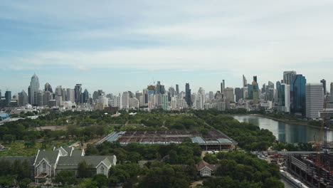 Queen-Sirikit-National-Convention-Centre-construction-site-near-Benjakitti-Park-and-Lake,-Millenium-Residence-Apartment,-CTI-Tower,-Ocean-Tower-in-Bangkok,-on-Sunny-day-from-Top,-cityscape-time-lapse