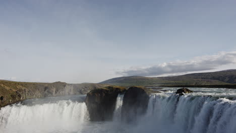 Wide-panoramic-tilt-down-to-reveal-clip-of-the-Godafoss-Waterfalls-in-Iceland---Nature,-adventure-and-majesty-concepts
