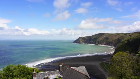 View-over-Lynmouth-Bay-from-Lynton-on-a-fine-summers-day-showing-waves-rolling-onto-the-rocky-pebble-beach-of-Blacklands-Beach