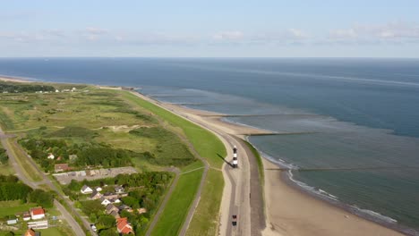 Aerial-orbit-over-the-lighthouse-on-the-shore-of-Waterdunes---a-nature-area-and-recreational-park-in-the-province-of-Zeeland,-The-Netherlands