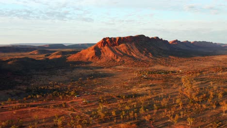 Distant-View-Of-The-Rocky-Mountain-Amidst-The-Red-Sand-Dunes-In-Alice-Springs-Town,-Australia