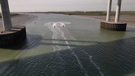 View-Of-Jet-Ski-Speed-Racing-Under-Sheppey-Crossing-At-Sunny-Day-In-Kent,-United-Kingdom