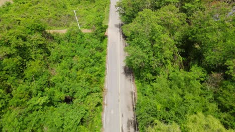 A-reverse-footage-taken-with-a-drone-of-the-road-going-in-Kaeng-Krachan-National-Park,-UNESCO-World-Heritage-site,-Thailand