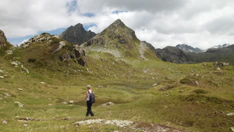 Young-sporty-girl-hiking-in-wild-alpine-mountain-landscape-terrain-in-austria-tirol