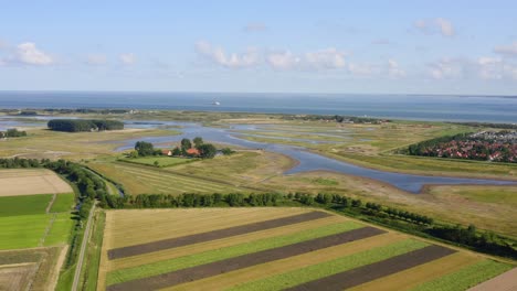 Aerial-high-altitude-wide-shot-of-the-North-Sea-and-Waterdunes---a-nature-area-and-recreational-park-in-the-province-of-Zeeland,-The-Netherlands