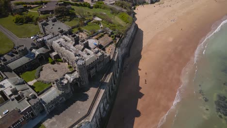 Kingsgate-castle-Kent-chalk-cliff-British-coastal-bay-landmark-Aerial-top-down-view-right-orbit-tilting-up