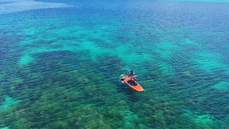 Man-Paddling-On-The-Shore-Of-Tagbak-Marine-Park-With-A-View-Of-The-Coral-Reef-Underwater-In-Southern-Leyte