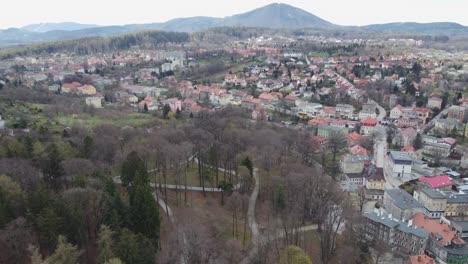 Aerial-panoramic-view-of-a-spa-town-with-traditional,-post-German-architecture,-during-an-overcast-day
