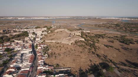 Aerial-descending-shot-of-Forte-de-Sao-Sebastiao-in-Castro-Marim,-Algarve,-Portugal