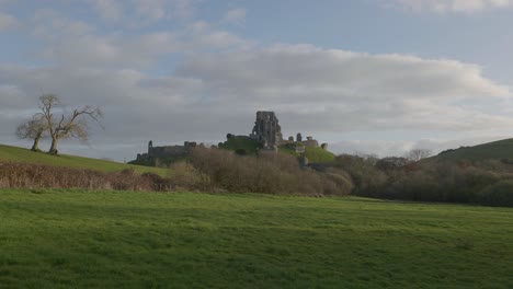 Slow-zoom-in-shot-of-Corfe-Castle-with-moving-clouds-over-the-scene
