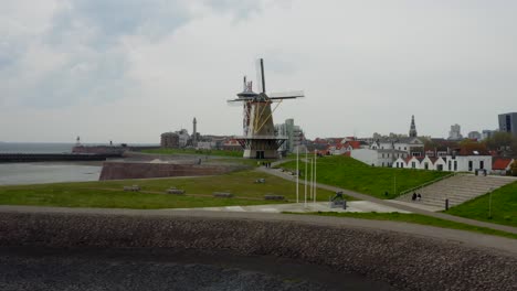 Aerial-orbit-approach-to-the-fortified-pier-with-Oranjemolen-windmill-in-Vlissingen,-the-Netherlands