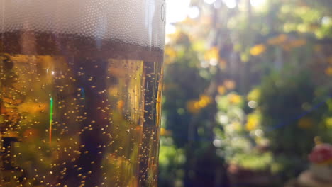 Close-up-of-a-cold-glass-of-beer-with-bubbles-and-foam