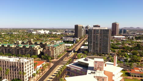 Drone-Flying-Over-High-rise-Buildings-In-Phoenix-On-A-Sunny-Summer-Day-In-Arizona,-USA
