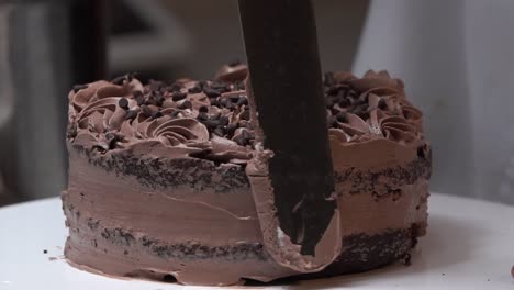 icing-on-choco-chocalet-chip-falling-on-the-second-layer-cake-cream-cinematic-slow-motion