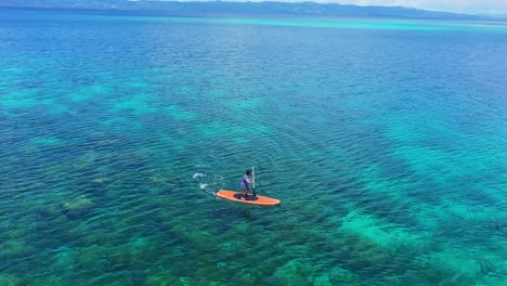 Stand-Up-Paddling-On-Shallow-Sea-Surface-In-Tagbak-Marine-Park-In-Southern-Leyte-At-Summer