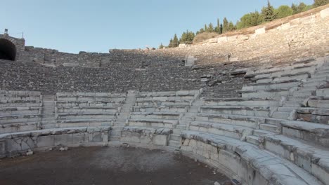 Left-side-panning-shot-of-The-Bouleuterion,-Odeon-ancient-semi-circular-theatre-in-Ephesus-Turkey
