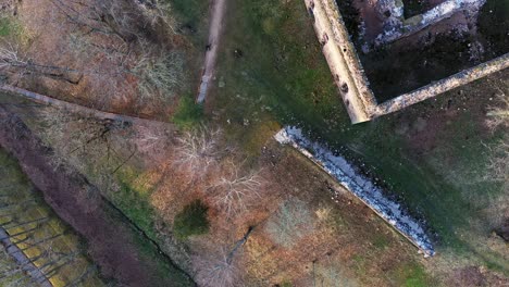Medieval-castle-ruins-while-drone-descending,-top-down-view