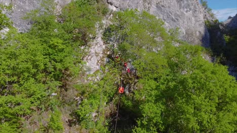 Rescue-team-transporting-emergency-stretcher-on-a-zip-line-drone-shot