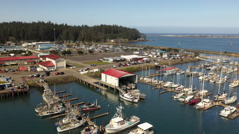 Fly-with-drone-over-buildings-and-boats-at-Charleston-Harbor,-Oregon