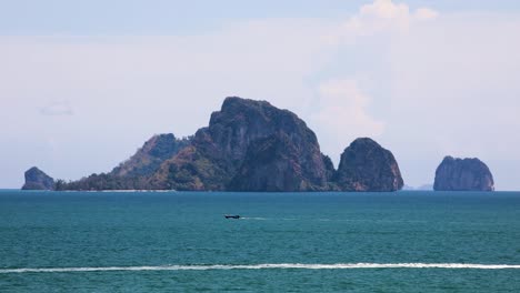 Timelapse-of-boats-at-Ao-Nang,-Krabi-with-Koh-Poda-in-the-background-on-a-sunny-day-in-Thailand