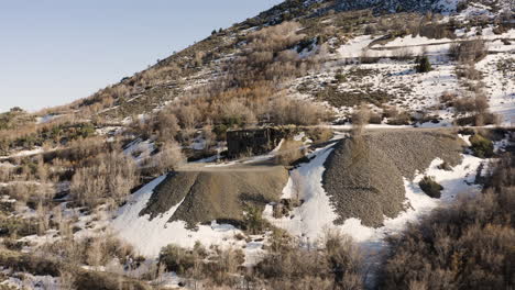 Derelict-building-on-mountainside-with-snow-in-Eureka,-Utah