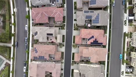 Aerial-Birdseye,-Tustin-houses-with-solar-panels-on-roof,-community-in-residential-neighborhood,-renewable-energy