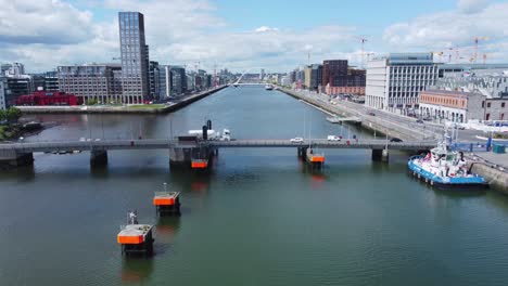Hovering-over-Liffey-river-in-Dublin,-behind-Tom-Clarke-Bridge