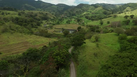 Four-wheel-car-on-dirt-road-in-lush-countryside-of-Costa-Rica,-aerial