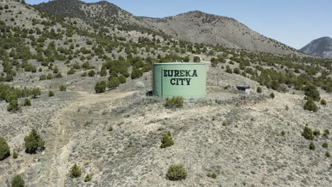 Slow-aerial-push-in-shot-over-the-water-tower-in-the-town-of-Eureka-City-Utah