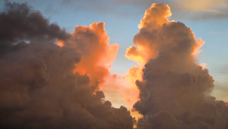 Slow-moving-cumulonimbus-clouds-with-sunset-glowing-behind-in-Thailand