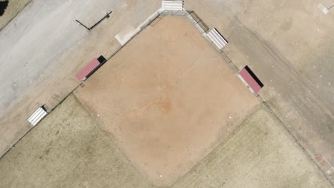 Birds-eye-view-descending-over-the-abandoned-baseball-field-of-Eureka-City-Utah-America