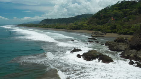 Costa-Rica-Coastal-habitat-with-Pelican-birds-soaring-in-air,-aerial