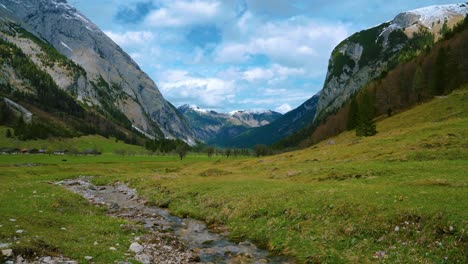 Cinemagraph-seamless-video-loop-of-the-scenic-and-idyllic-Ahornboden-mountain-canyon-with-the-river-Rissach-with-fresh-blue-water-in-the-Bavarian-Austrian-alps,-flowing-down-green-lush-fields