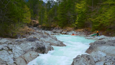 Slow-motion-Kayaking-at-Rissach-river-flowing-down-a-scenic-and-idyllic-mountain-kayak-canyon-with-fresh-blue-water-along-green-lush-trees-in-the-Bavarian-Austrian-alps-close-to-Engtal-and-Ahornboden
