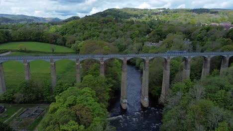 Aerial-view-Pontcysyllte-aqueduct-and-River-Dee-canal-narrow-boat-bride-in-Chirk-Welsh-valley-countryside-push-in-forwards