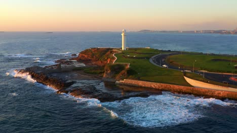 Aerial-view-of-Wollongong-Head-and-Lighthouse-with-Foamy-Waves-Crashing-In-NSW,-Australia