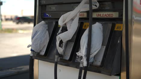 Gas-pumps-at-shut-down-fuel-petrol-station-with-plastic-bags-on-all-the-nozzles-due-to-gas-shortage-crisis-and-Covid-pandemic