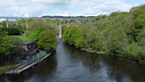 Aerial-view-Pontcysyllte-aqueduct-and-River-Dee-canal-narrow-boat-bride-in-Chirk-Welsh-valley-countryside-zoom-in-low-angle