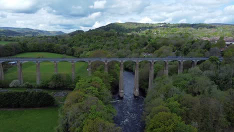 Aerial-view-Pontcysyllte-aqueduct-and-River-Dee-canal-narrow-boat-bride-in-Chirk-Welsh-valley-countryside-moving-forwards