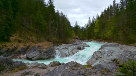 Cinemagraph-seamless-video-loop-of-the-scenic-and-idyllic-mountain-river-waterfall-canyon-Rissach-with-fresh-blue-water-in-the-Bavarian-Austrian-alps,-flowing-down-along-a-forest,-trees-and-rocks